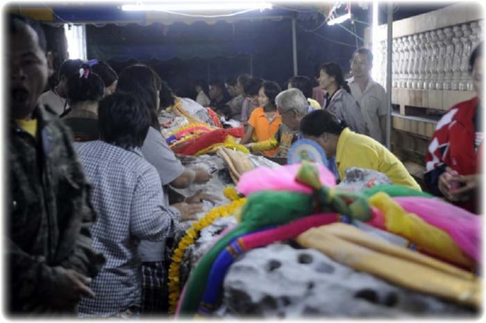 Sacred Ta-Khian Tree with Devotees Seeking Lottery Numbers